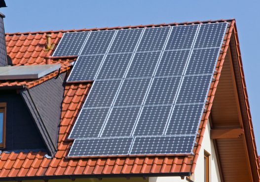 Solar panels mounted on a terracotta tiled roof