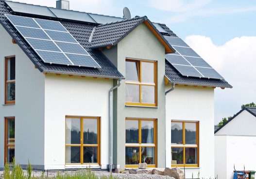 dreamstime_s_5397638 Solar panels mounted on the roof of a white house