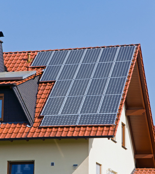 Solar panels mounted on a terracotta tiled roof