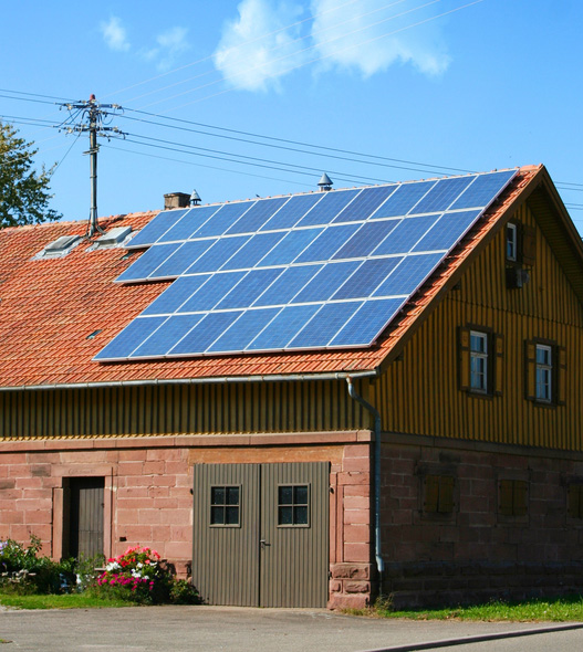 Solar panels mounted on half of a roof of a house