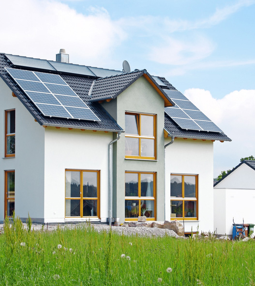 Solar panels mounted on the roof of a white house